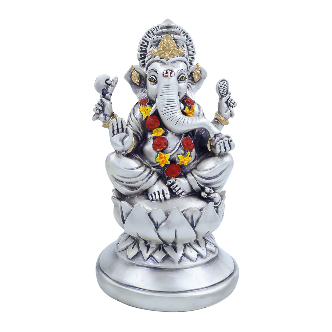Antique silver-finish Ganesh idol seated on a lotus base with floral garland – ideal for pooja room or festive decor.