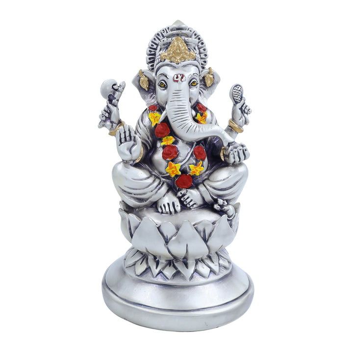 Antique silver-finish Ganesh idol seated on a lotus base with floral garland – ideal for pooja room or festive decor.