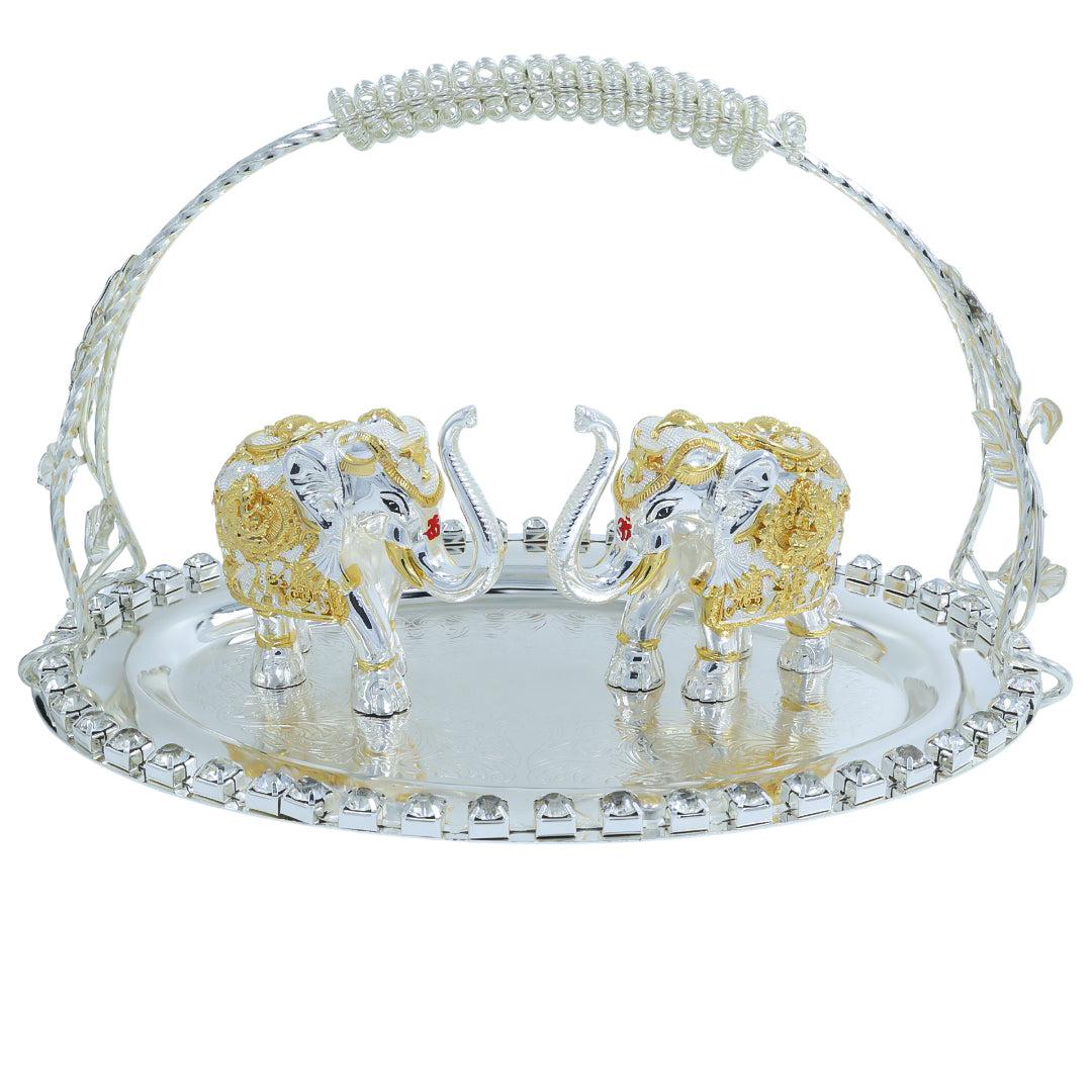 Two golden and white decorative elephants placed on a transparent crystal-style tray with a curved handle – ideal for festive gifting and home décor.