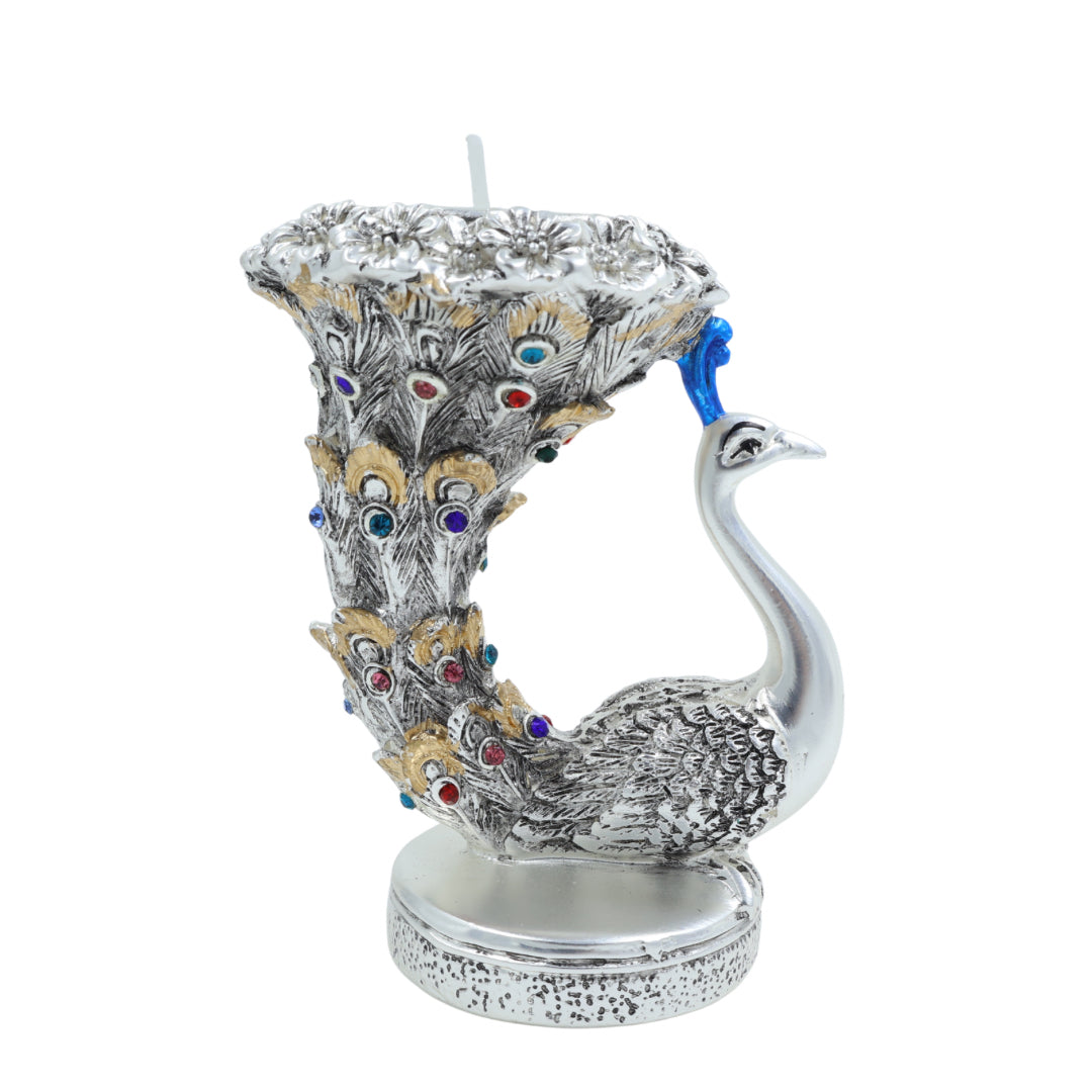 Silver peacock tealight holder with curved feather tail adorned with multicolored stones, designed for festive or spiritual decoration.