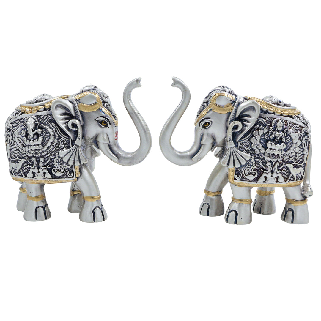 Decorative silver antique elephant pair with detailed embossing and raised trunks, ideal for gifting and Indian home decor.