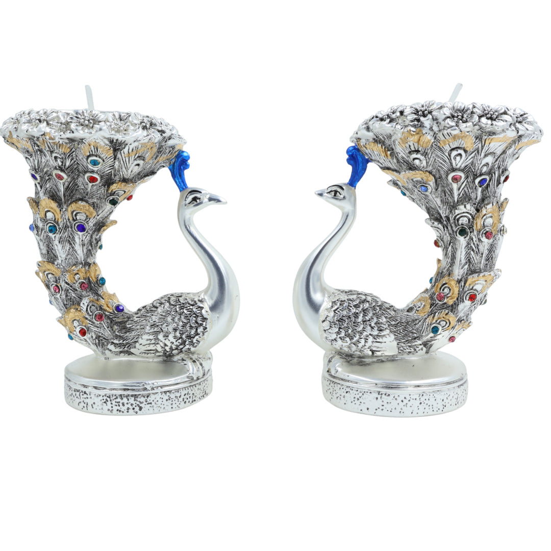Pair of silver peacock tealight holders with upward feather tails decorated with multicolor stones, perfect for festive or spiritual décor.